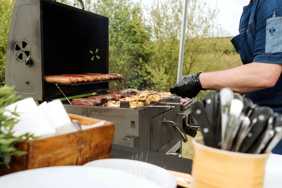 Dave Rees of Frisky Pheasant cooking over an open flame at a Tree Top Escape wedding in North Devon