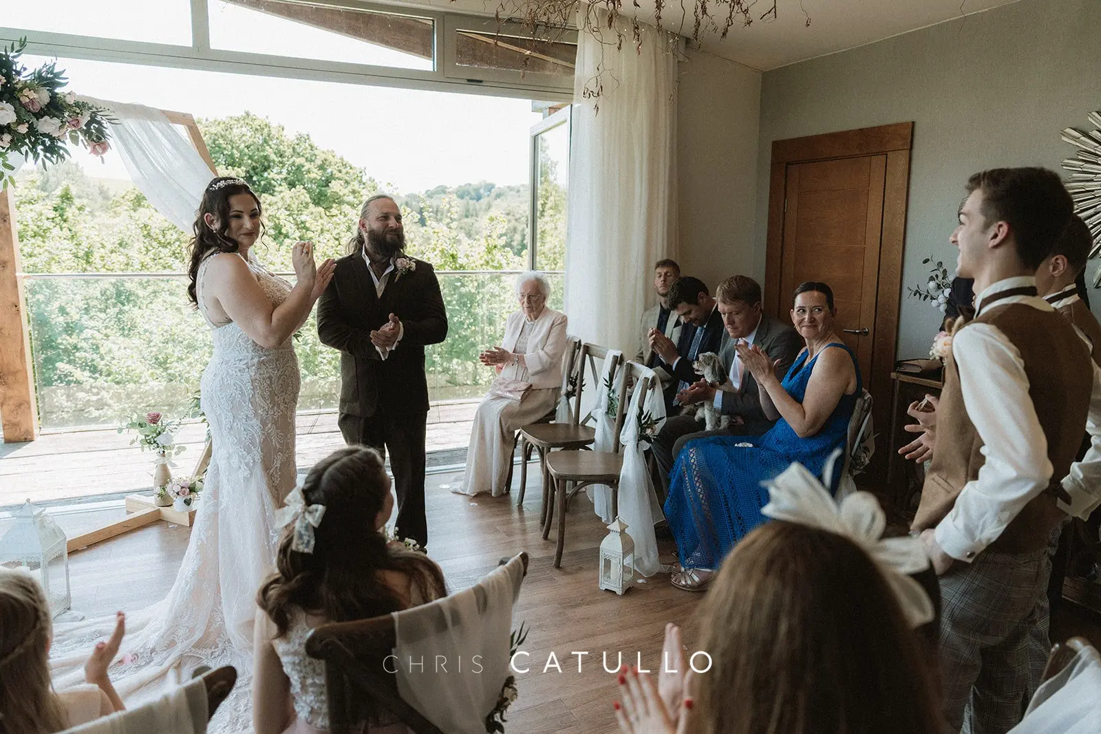 Guests celebrating Kelly and Dave's first kiss as husband and wife