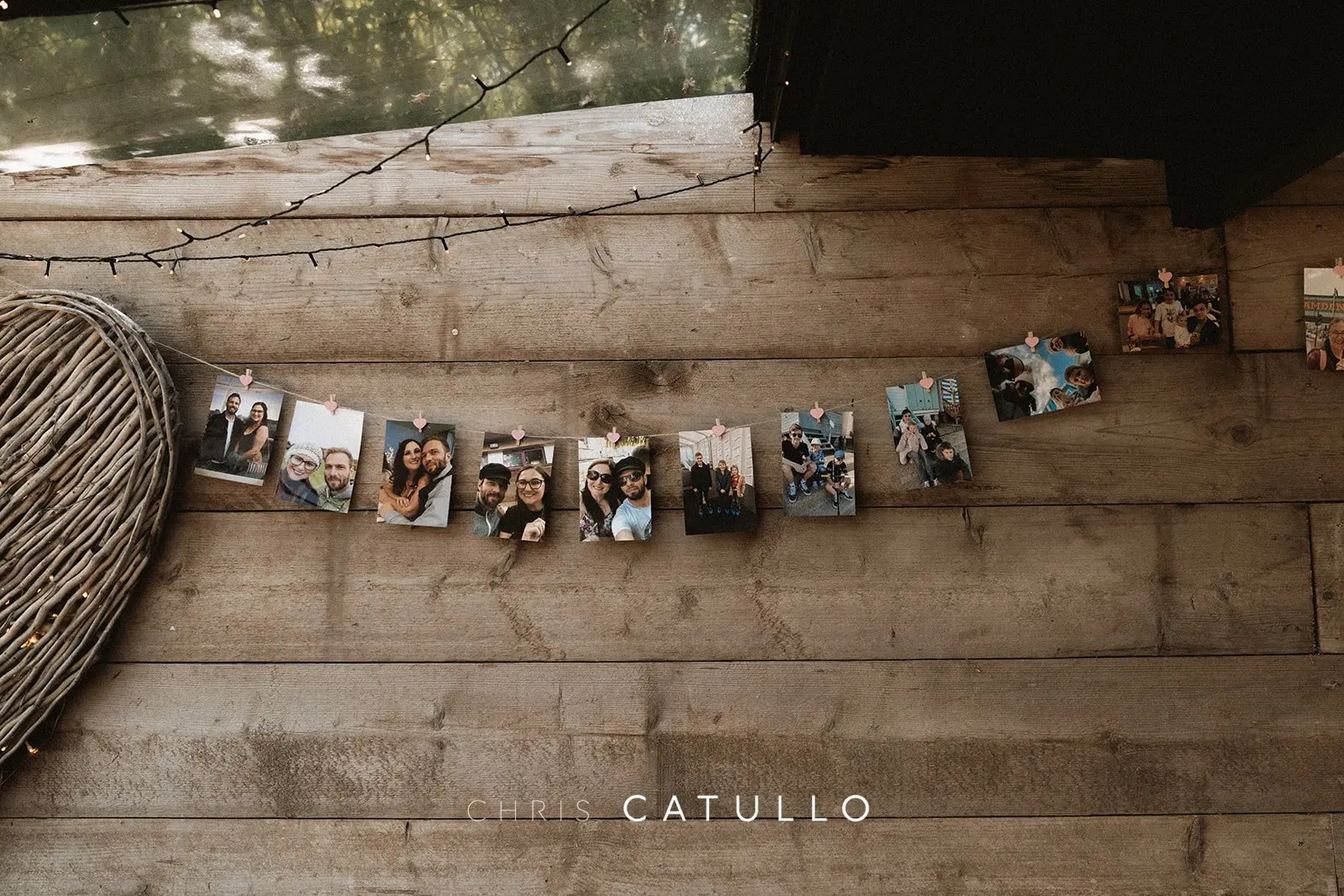 A garland of guest Polaroid photographs displayed at Kelly and Dave's wedding