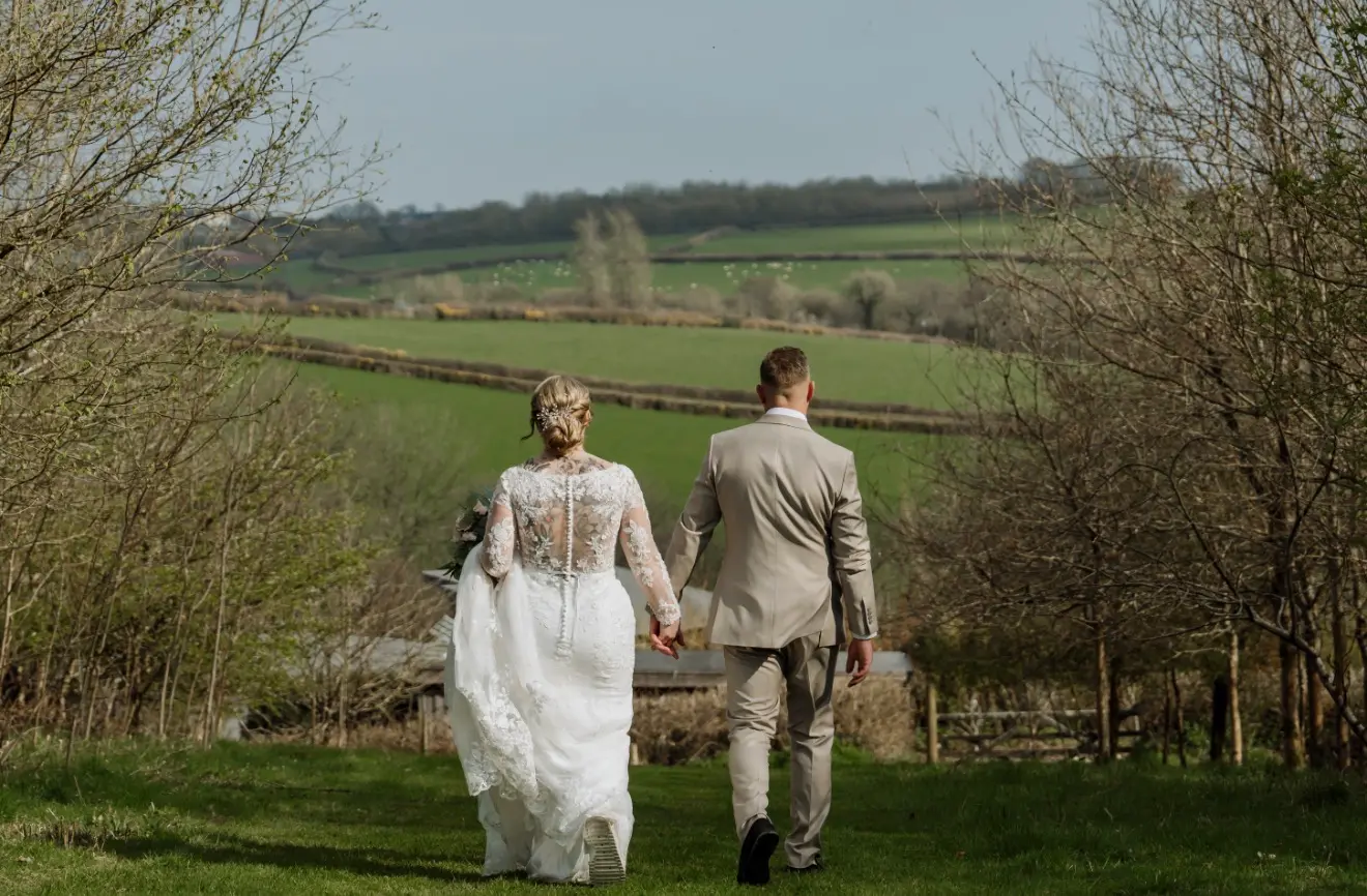 Kelly and Ryan walking hand in hand through the Devon countryside