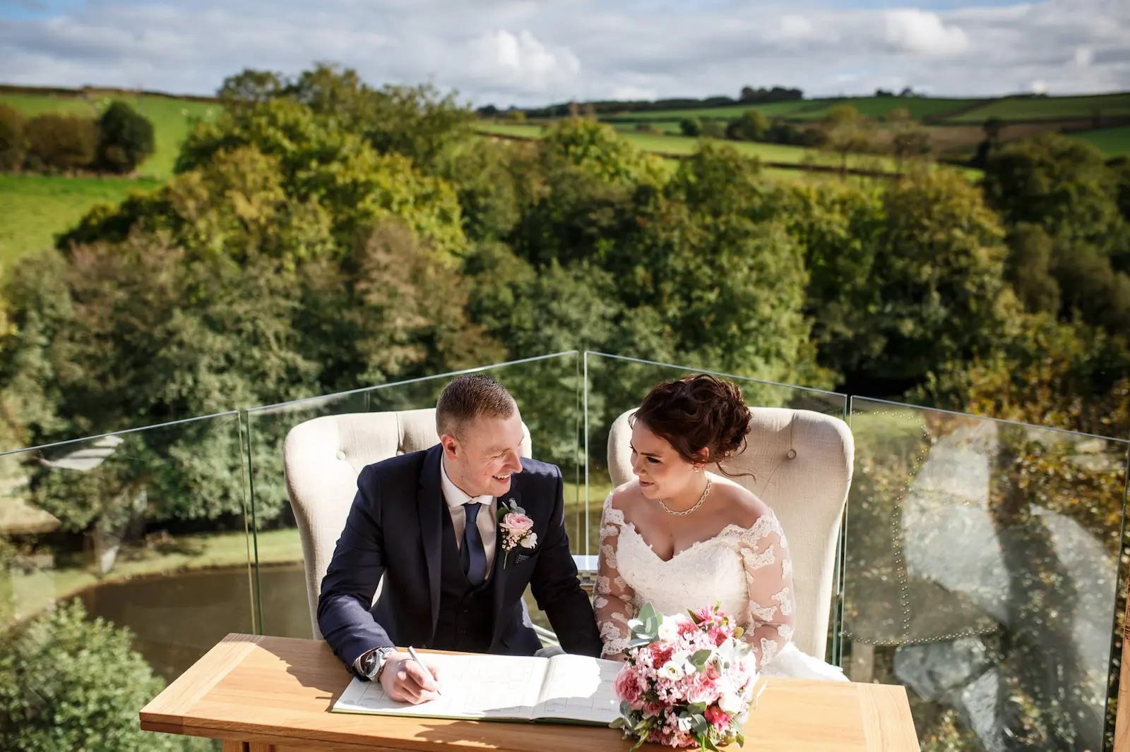 Couple signing the register at their intimate wedding at Tree Top Escape, Devon